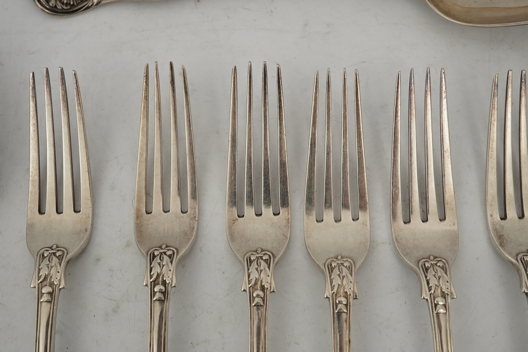 A part canteen of early Victorian silver flatware, by Robert Wallis, double struck with an unusual pattern with entwined cornucopia and a raised star terminal